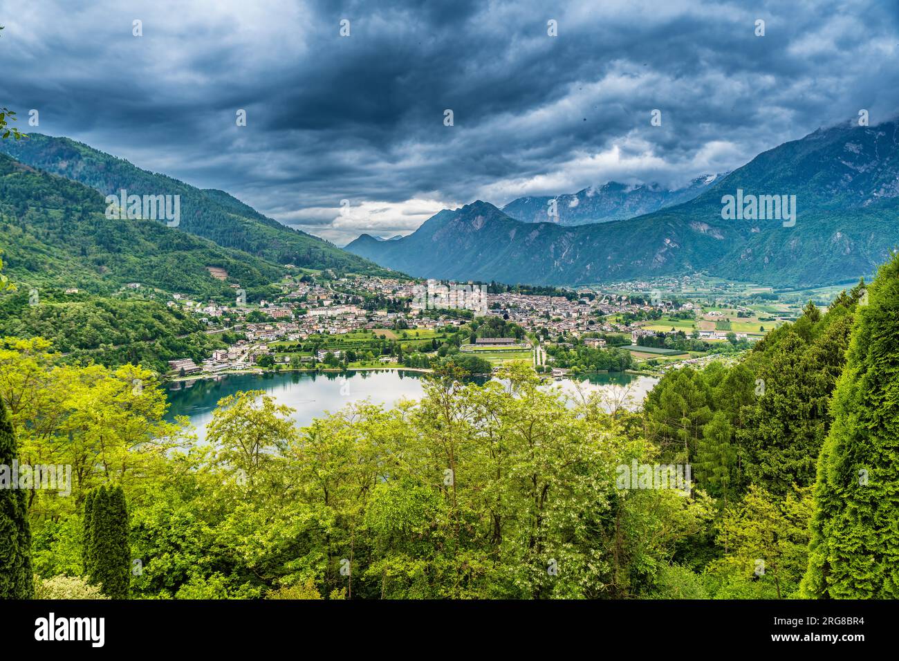 Lago Levico con la ciudad de Levico Terme, Italia Foto de stock