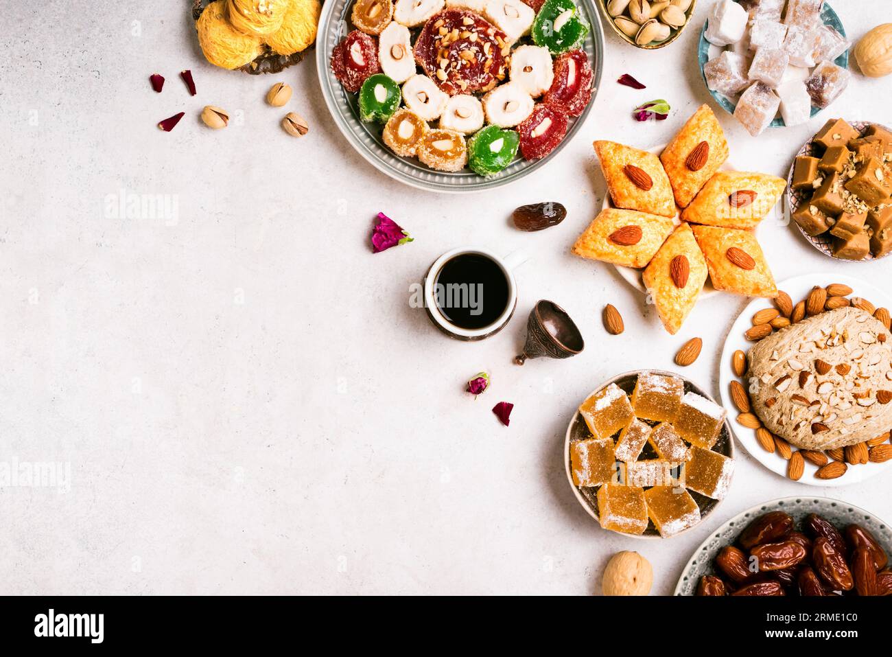 Dulces de Oriente Medio, delicias turcas y café sobre fondo blanco, espacio de copia. Surtido de postres árabes, rahat lokum, halva, sherber, pismaniye wi Foto de stock