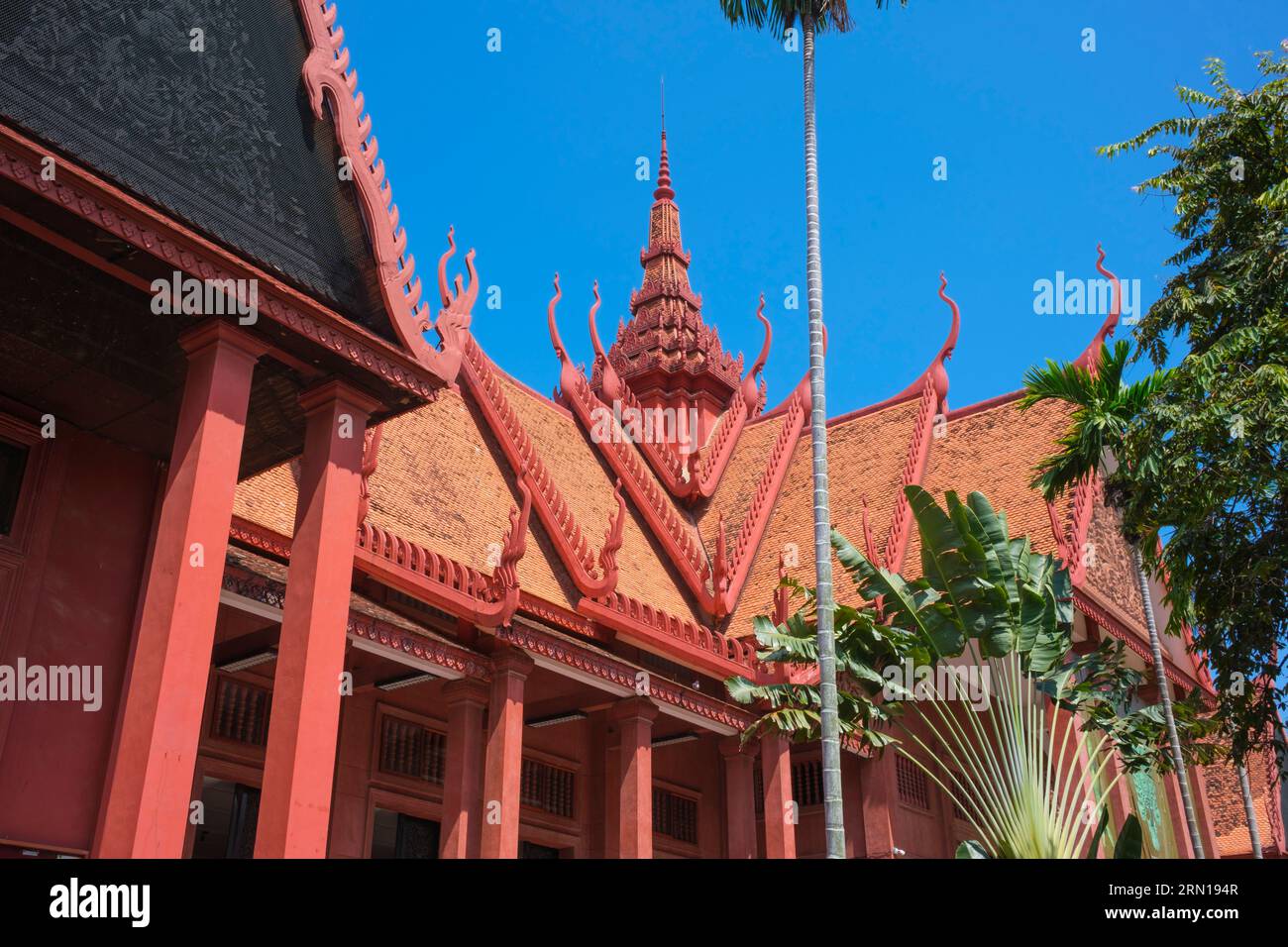 Camboya: Museo Nacional de Camboya, Phnom Penh, diseñado por George Groslier (1887 - 1945). El Museo Nacional, ubicado en un pabellón rojo construido en 1918, alberga una colección de arte jemer que incluye algunas de las mejores piezas existentes. Las exposiciones incluyen una estatua de Vishnu del siglo VI, una estatua de Shiva del siglo IX y la famosa cabeza esculpida de Jayavarman VII en pose meditativa. Particularmente impresionante es un busto dañado de un Vishnu reclinado que una vez fue parte de una estatua de bronce masiva encontrada en el Templo de Mebon Occidental en Angkor. Foto de stock