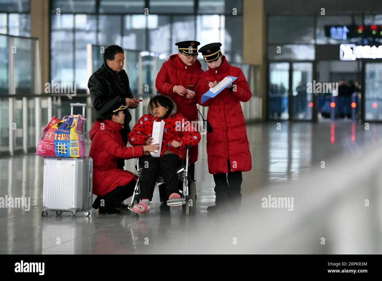 200116 -- BENGBU, 16 de enero de 2020 -- Liu Fengmin 2ª R y sus aprendices sirven a pasajeros en la estación de tren de Bengbu en Bengbu, provincia de Anhui, en el este de China, 15 de enero de 2020. Liu Fengmin, un asistente de servicio de pasajeros de la estación de tren de Bengbu de China Railway Shanghai Group Co., Ltd., se retirará a finales de 2020. Durante la carrera de viajes del Festival de Primavera de este año, además de cumplir con su deber de servir a los pasajeros, Liu ha cargado otra responsabilidad, que está cultivando sucesores para el estudio Hongxiang. El estudio Hongxiang fue fundado por Lu Hongxiang, un antiguo asistente de Bengbu Foto de stock