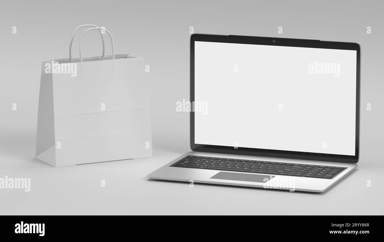 Portátil y bolsa de compras mockup sobre fondo blanco. Negocio y concepto de objeto de tecnología en línea. Visualización de pantalla vacía para inse Foto de stock