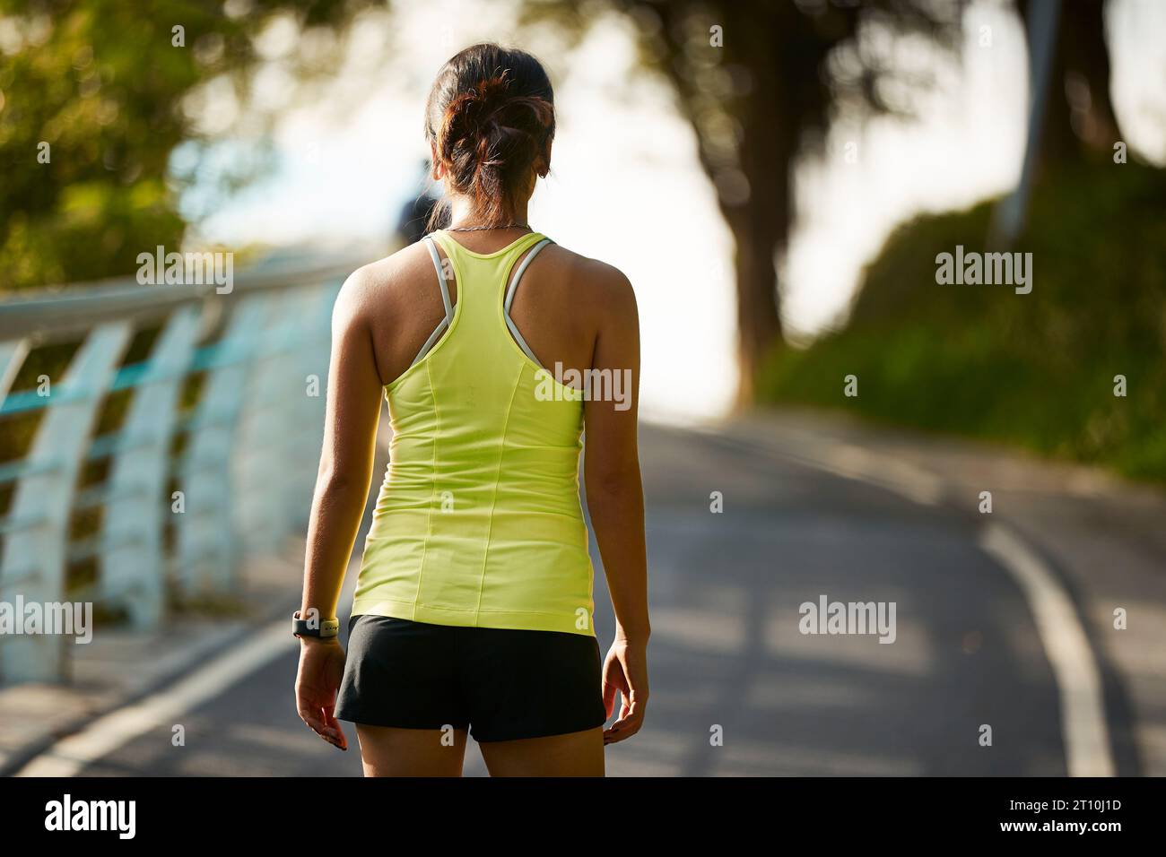 joven mujer asiática jogger femenino que hace ejercicio al aire libre en el parque de la ciudad Foto de stock