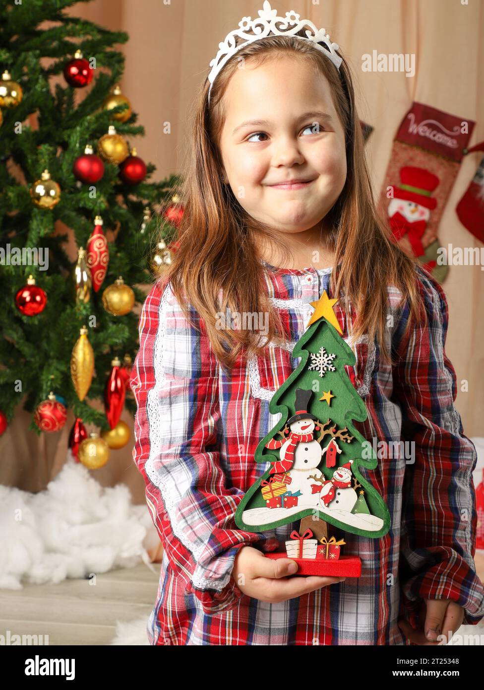 Hermosa niña frente al árbol de Navidad Foto de stock