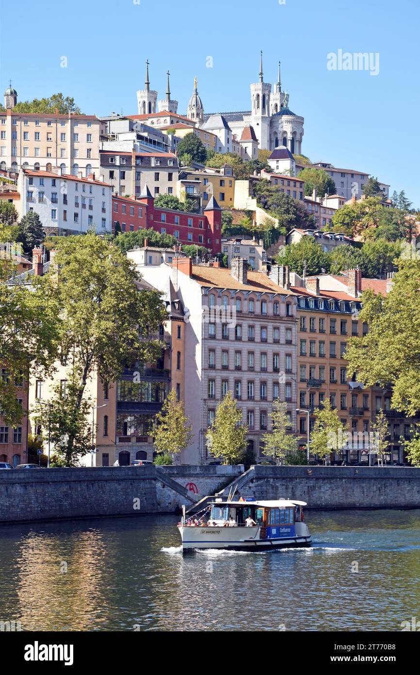 La Basílica de Notre-Dame de Fourvière en un promontorio empinado, con vistas a la ciudad de Lyon y el río Sâone, edificios de apartamentos frente al río Foto de stock