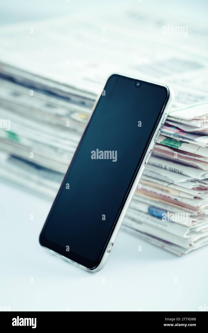 Concepto de nueva prensa online. Periódicos o revistas con celular. Última prensa diaria y medios de comunicación. Foto de stock