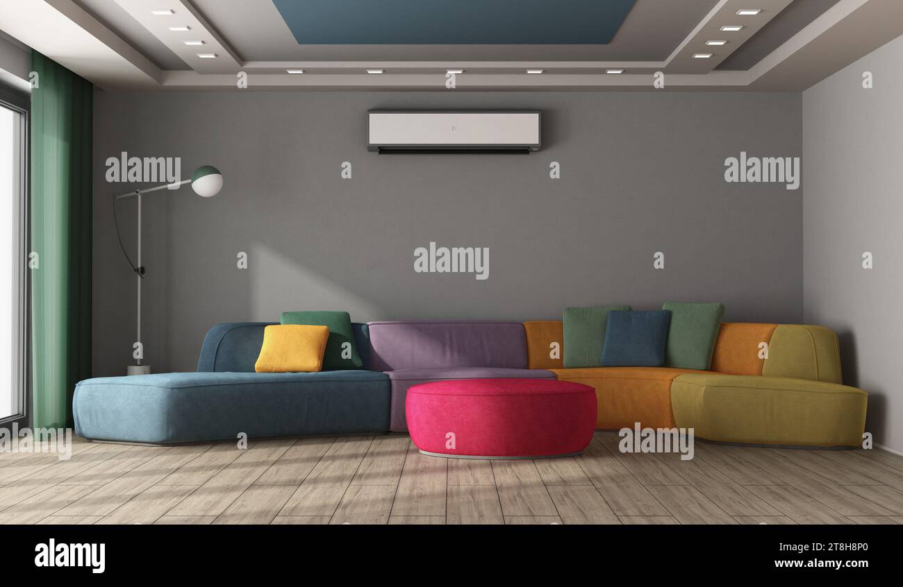 Gran sofá multicolor en una habitación moderna con pared gris, lámpara de pie, aire acondicionado y techo con foco de atención - representación 3D. Foto de stock