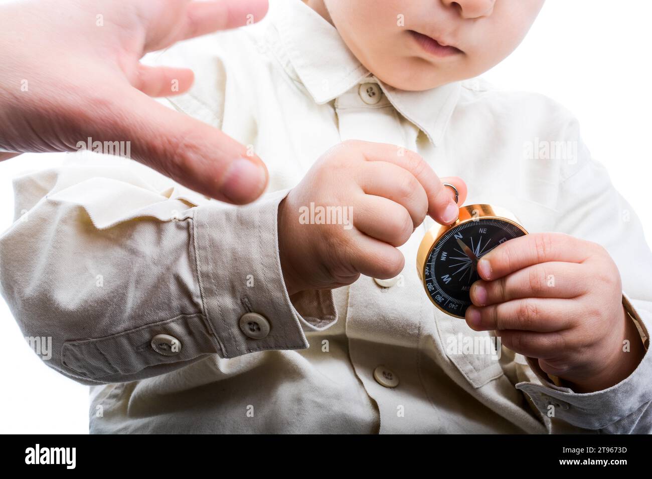 Mano del niño sosteniendo una brújula sobre un fondo negro Fotografía de  stock - Alamy