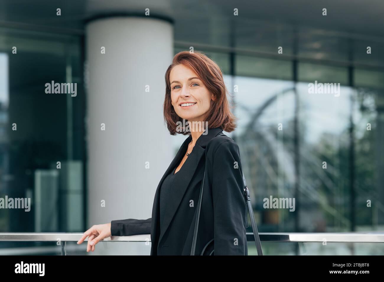 Mujer de negocios en elegante traje formal azul posando al aire