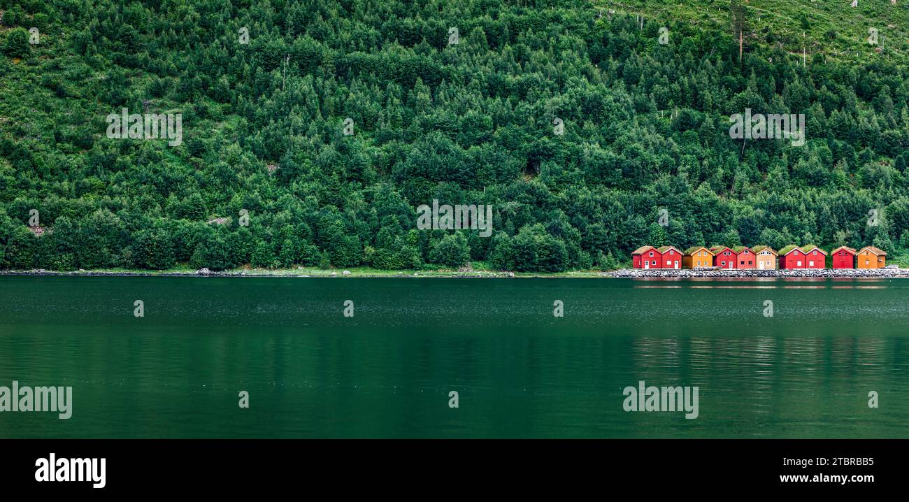 Casas de barcos rojos en un lago verde en Escandinavia Foto de stock