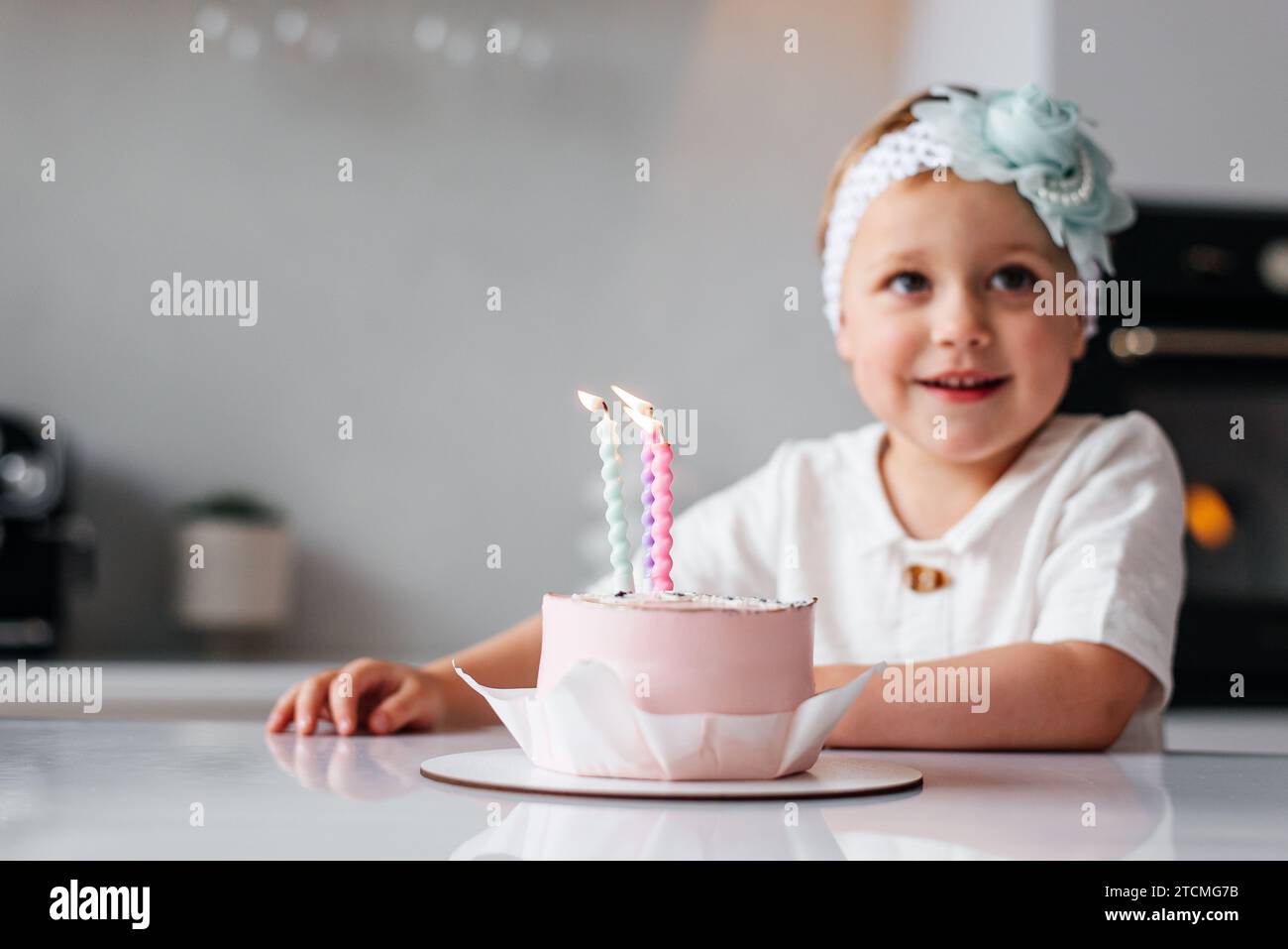 feliz cumpleaños niña de 2 años con vestido rosa. pastel blanco con velas y  rosas. Decoración de cumpleaños con globos de color blanco y rosa y  Fotografía de stock - Alamy