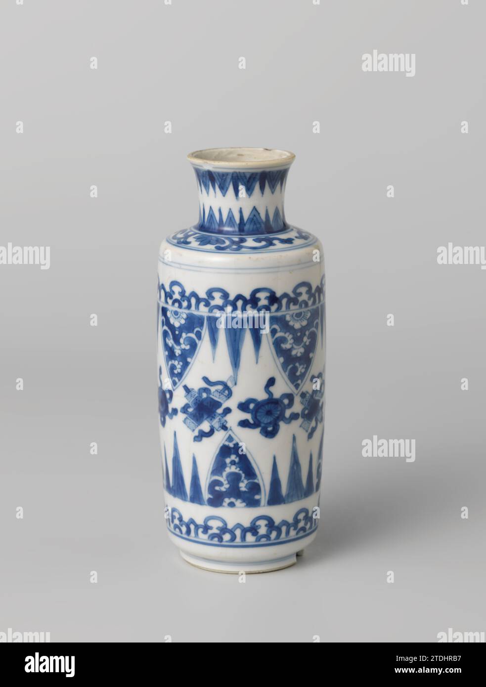 Jarrón cilíndrico con símbolos auspiciosos, pergaminos y bordes de pétalos, anónimo, c. 1680 - c. 1720 Jarrón cilíndrico en forma de botella de porcelana con hombro plano y cuello corto, ancho, acampanado, pintado en azul bajo esmalte. En la pared un vínculo con los objetos de la suerte (menta, rodando). Por debajo y por encima de un vínculo con ramas y uno con motivos de hojas puntiagudas con rangos guardados. En el hombro lotus vrocks. El cuello con dos neumáticos con motivos de hojas puntiagudas. Un chip en el borde y en el pie. Azul Blanco. Porcelana de China. esmalte. Pintura de cobalto (mineral) / vitrificación cilíndrica, botella en forma de lienzo Foto de stock