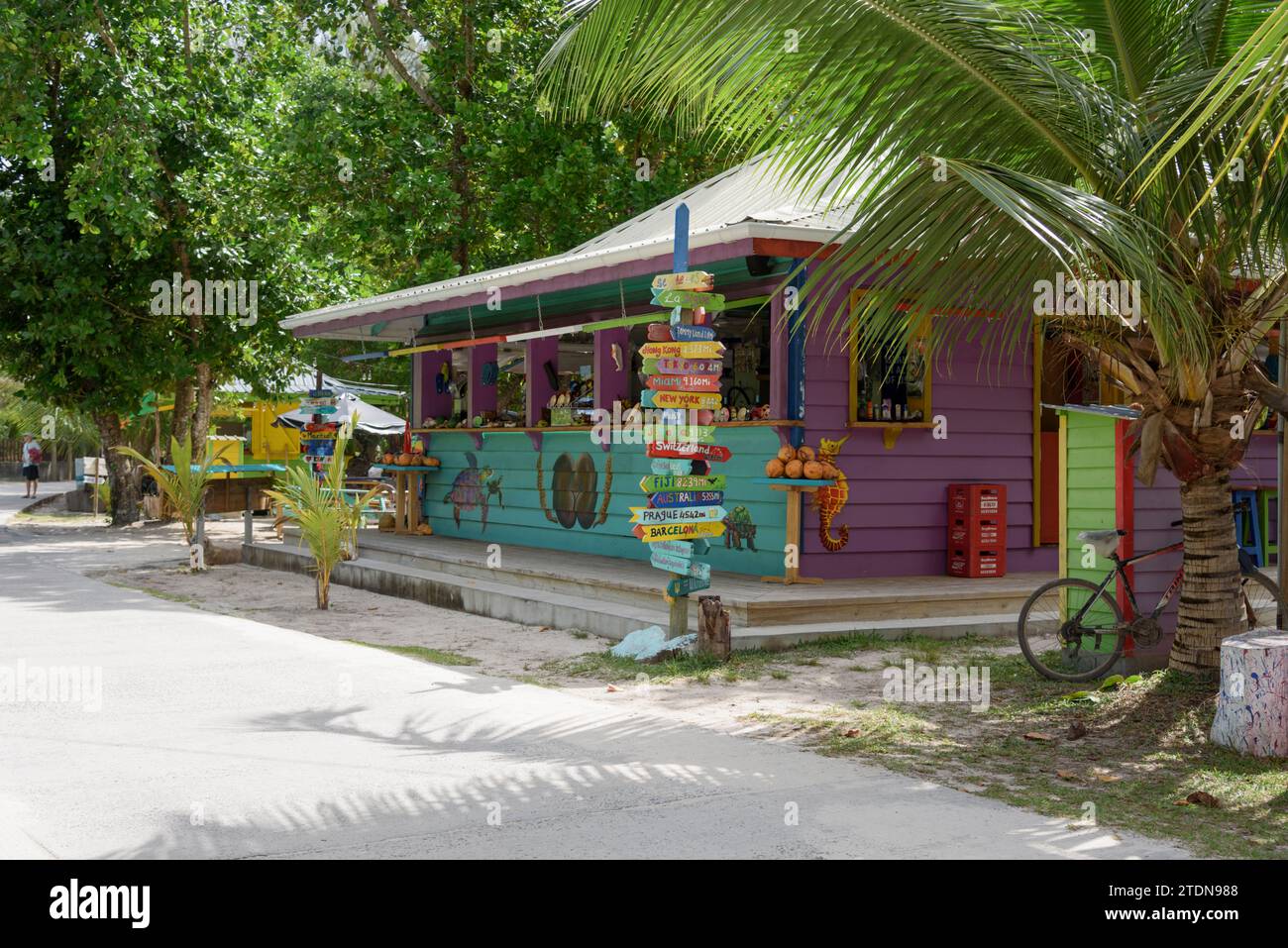 Colorida tienda de recuerdos de madera pintada para turistas en la playa de Anse Severe, la isla de La Digue, Seychelles, Océano Índico, África Foto de stock