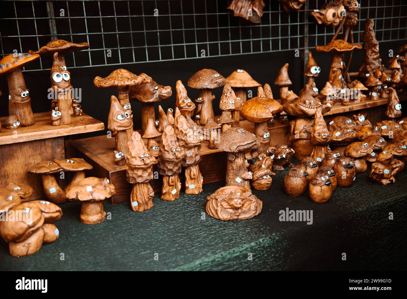 Una colorida variedad de artesanías de madera y artesanías se exhiben en un mercado local Foto de stock