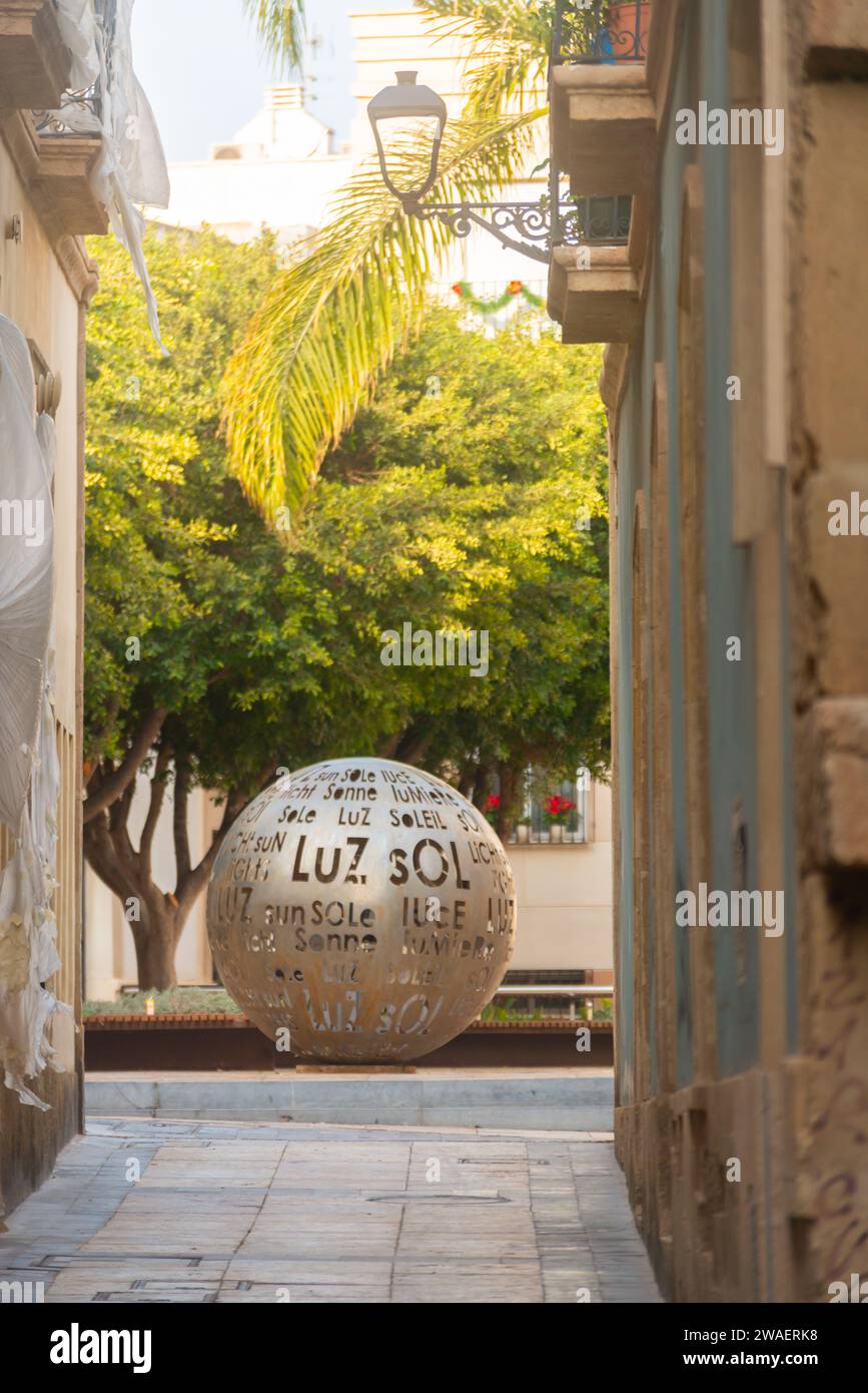 ALMERÍA, ESPAÑA - 11 DE DICIEMBRE de 2023 Un monumento de una bola luminosa en una de las pequeñas plazas centrales de la ciudad de Almería, transmitiendo la más represa Foto de stock