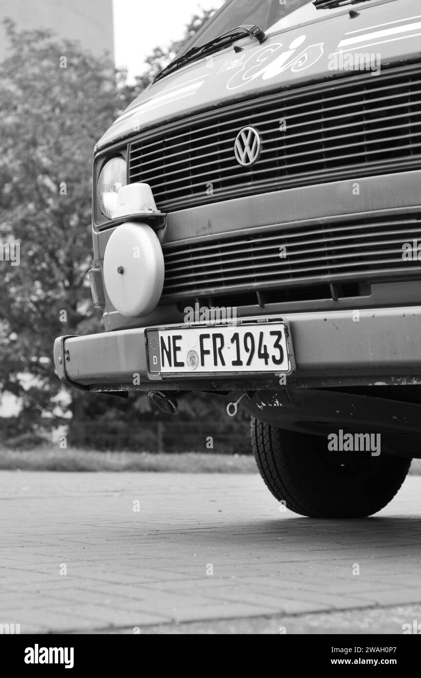 Foto en escala de grises de la furgoneta de helados VW T3 Bulli con una campana en el puerto de Media en Dusseldorf, Alemania Foto de stock