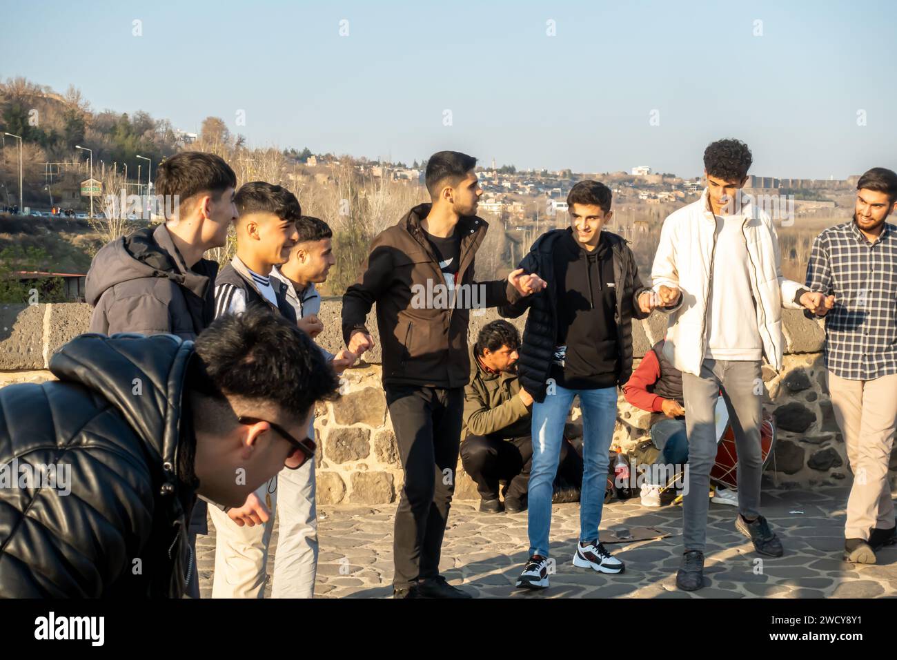 Danza tradicional kurda govend o danza tradicional turca Halay. Hombres kurdos realizan danza espontánea en el puente Diyarbakir en Turquía Foto de stock