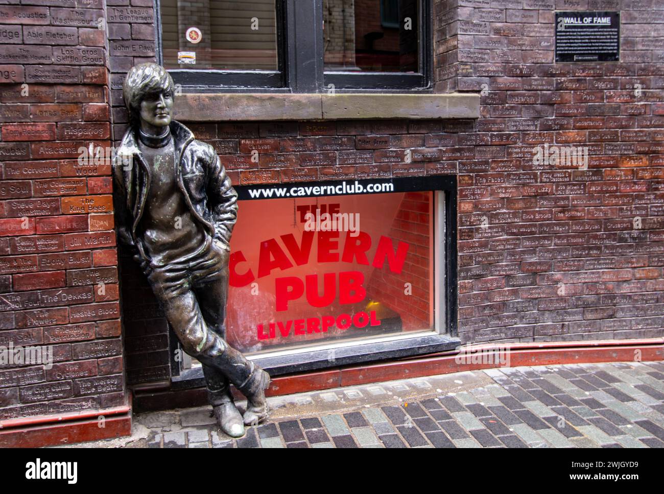 Caverna club Liverpool UK con la estatua de John Lennon apoyada contra la pared de la fama. Febrero de 2022 Foto de stock