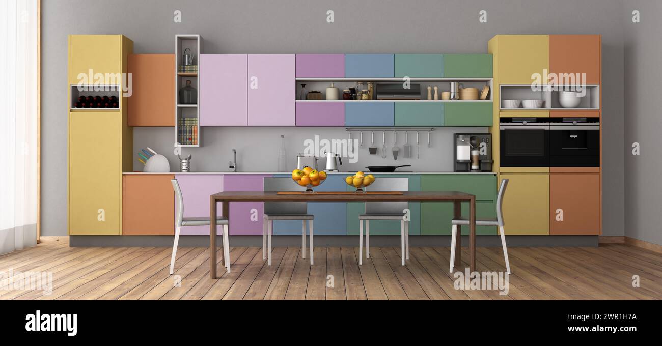 Cocina moderna con colores vibrantes del gabinete y mesa de comedor- representación 3D. Foto de stock