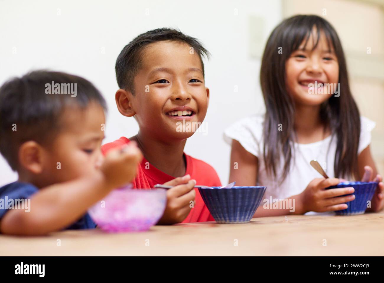 Niños comiendo hielo afeitado Foto de stock
