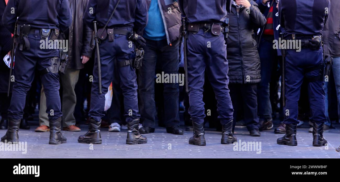 Un grupo de agentes de policía frente a algunos manifestantes Foto de stock