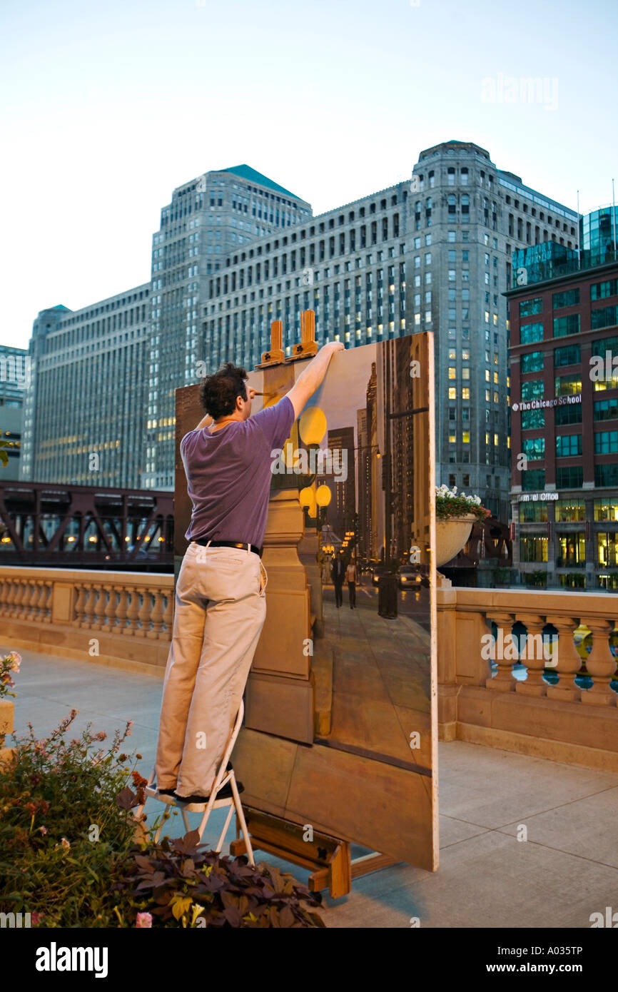 ILLINOIS Chicago Hombre de pie sobre el taburete para pintar grandes lienzos  a lo largo de Chicago River en el centro de la ciudad, área de bucle  Fotografía de stock - Alamy