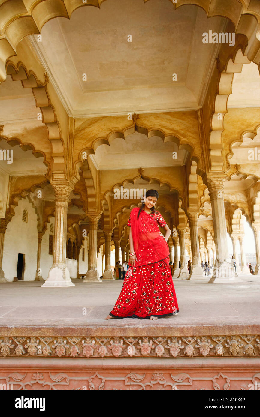 Retrato de una joven mujer de pie con sus manos sobre su cadera, el Fuerte de Agra, Agra, Uttar Pradesh, India Foto de stock