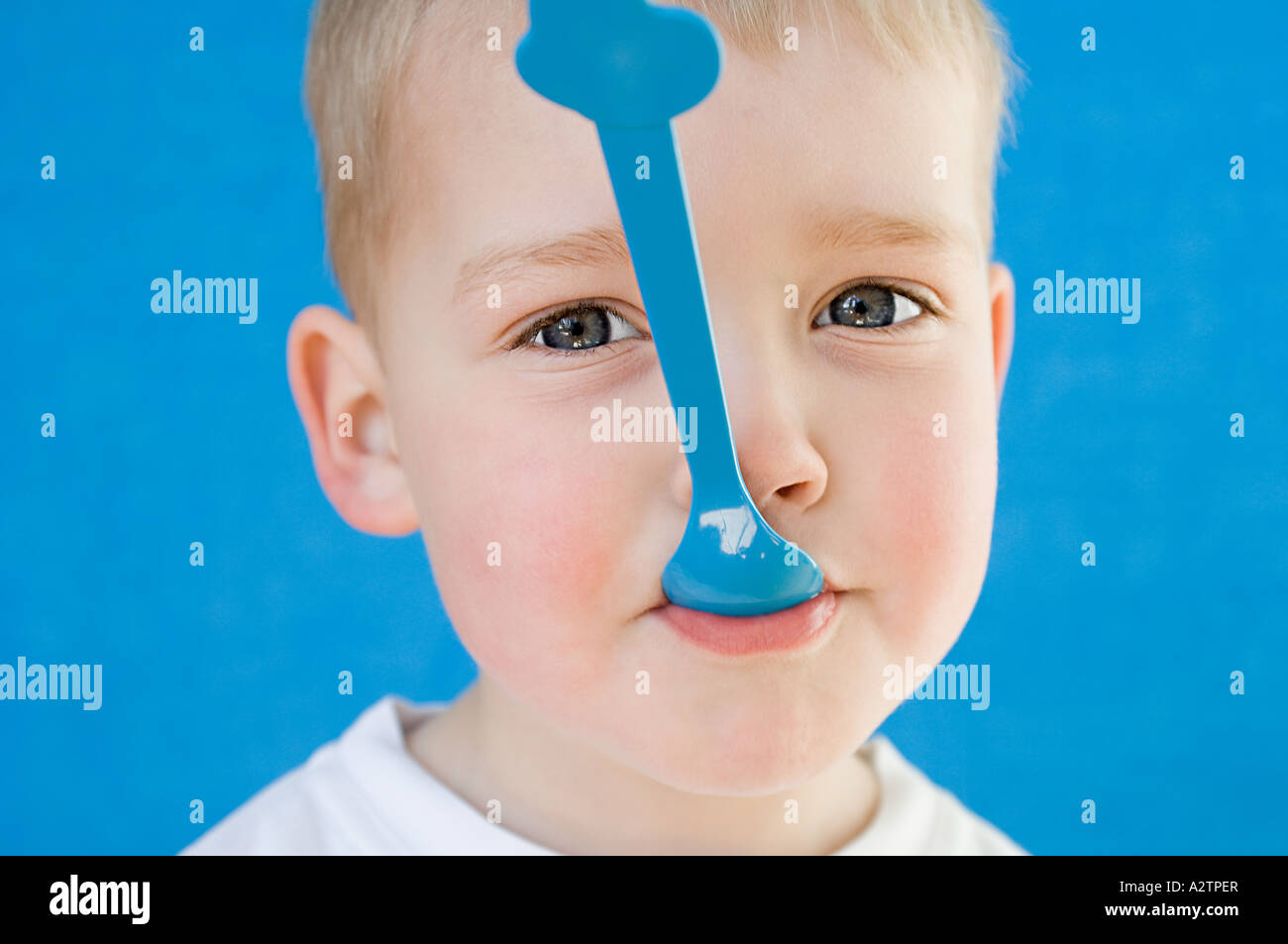 Niño con una cuchara en su boca Fotografía de stock - Alamy