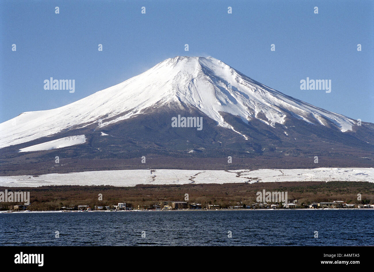 La cima nevada del Monte Fuji en Japón vistos en invierno contra un cielo azul brillante. Foto de stock