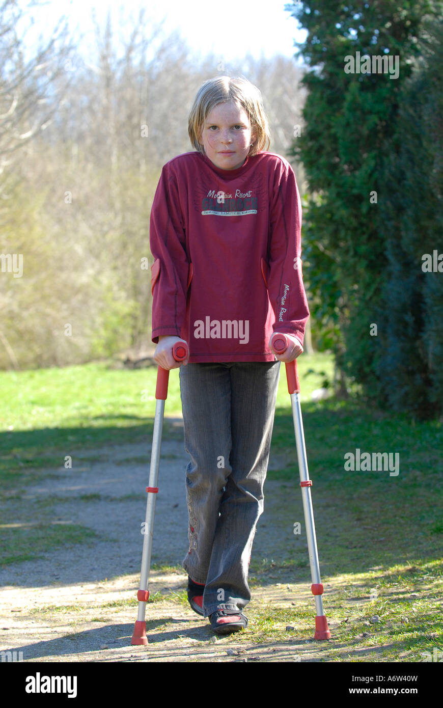 Niño de pie con muletas y sonriente Fotografía de stock - Alamy