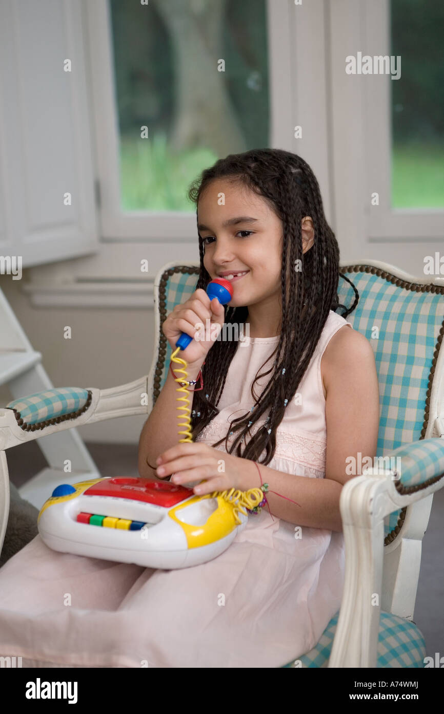 Niña cantando en un micrófono de juguete Fotografía de stock - Alamy