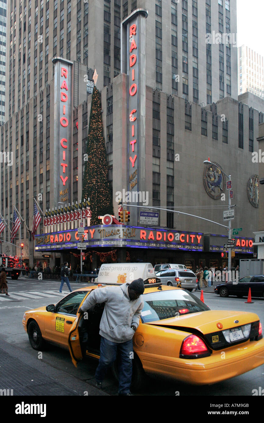 Un hombre saliendo de un taxi amarillo delante del Radio City Music Hall.  La ciudad de Nueva York. Ee.Uu.. Las vacaciones de Navidad Fotografía de  stock - Alamy