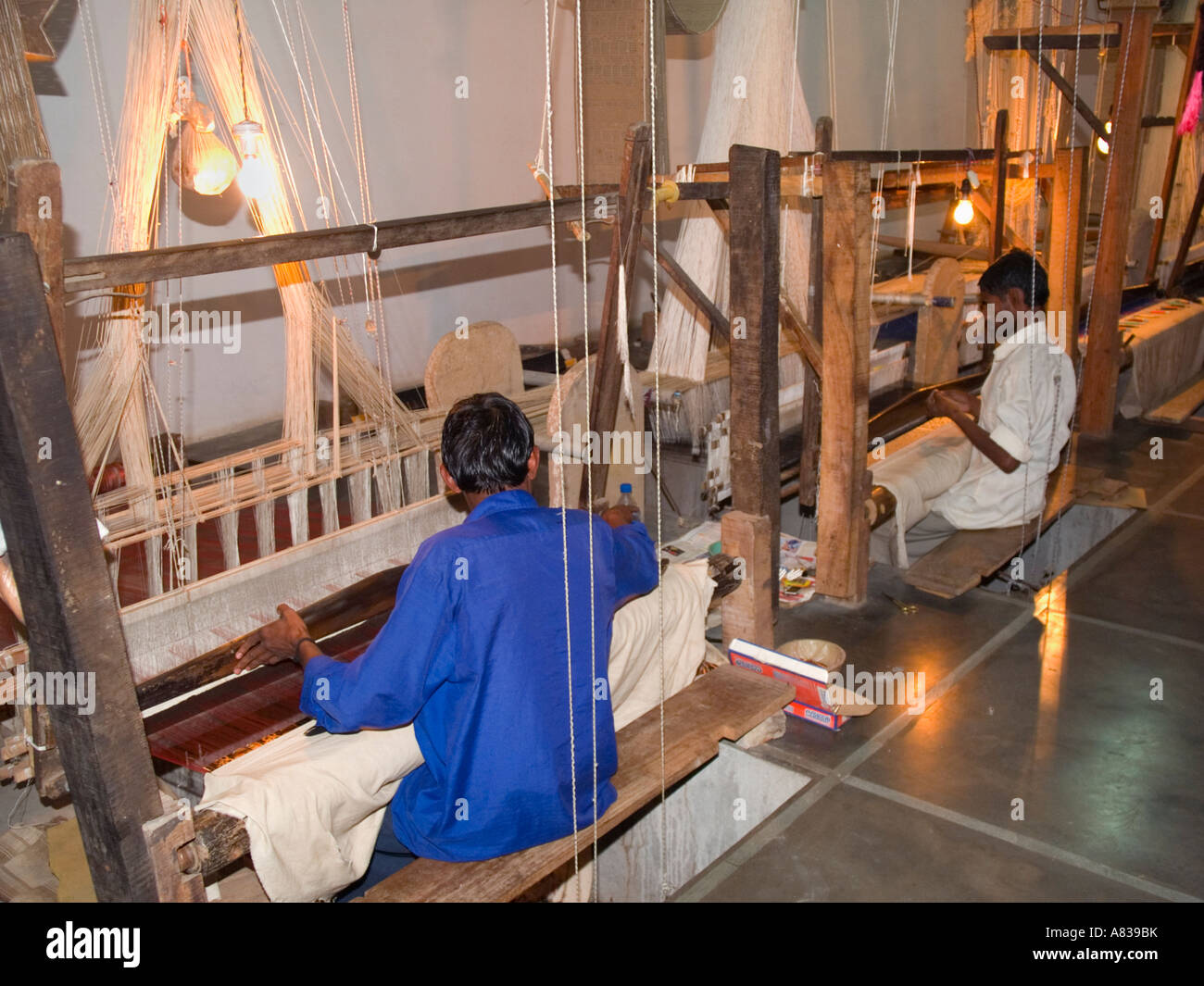 Varanasi Benarés en Uttar Pradesh, India sentaron trabajando en telares de tejer telas de seda en la fábrica. Foto de stock
