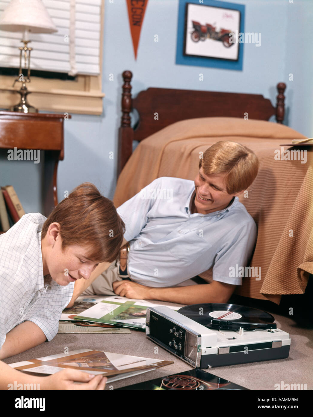 1970 dos chicos adolescentes tocadiscos portátil ESCUCHANDO MÚSICA REGISTROS EN Dormitorio Dormitorio Dormitorio Foto de stock