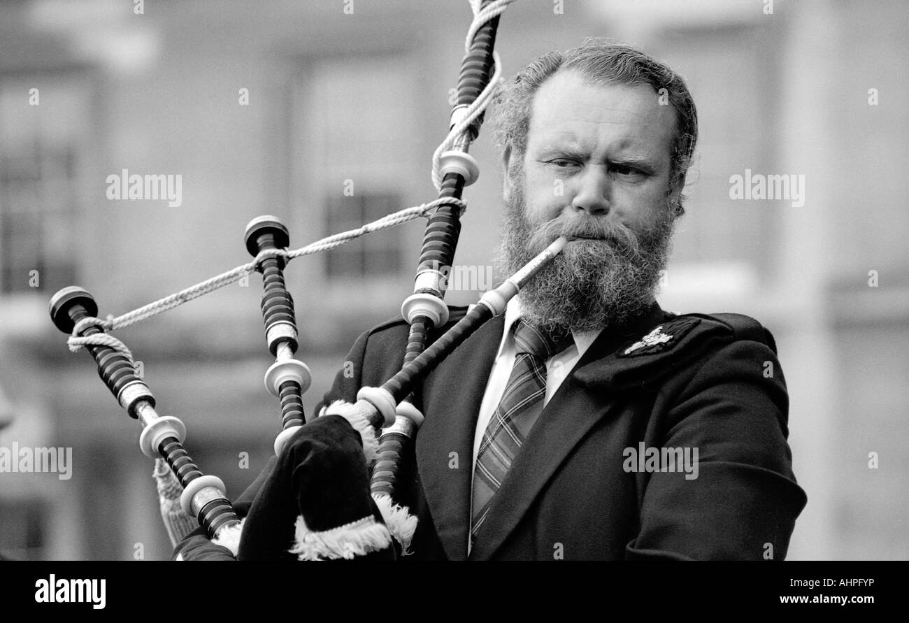 El hombre tocando la gaita en la cabeza y el hombro captura monocromo. Foto de stock