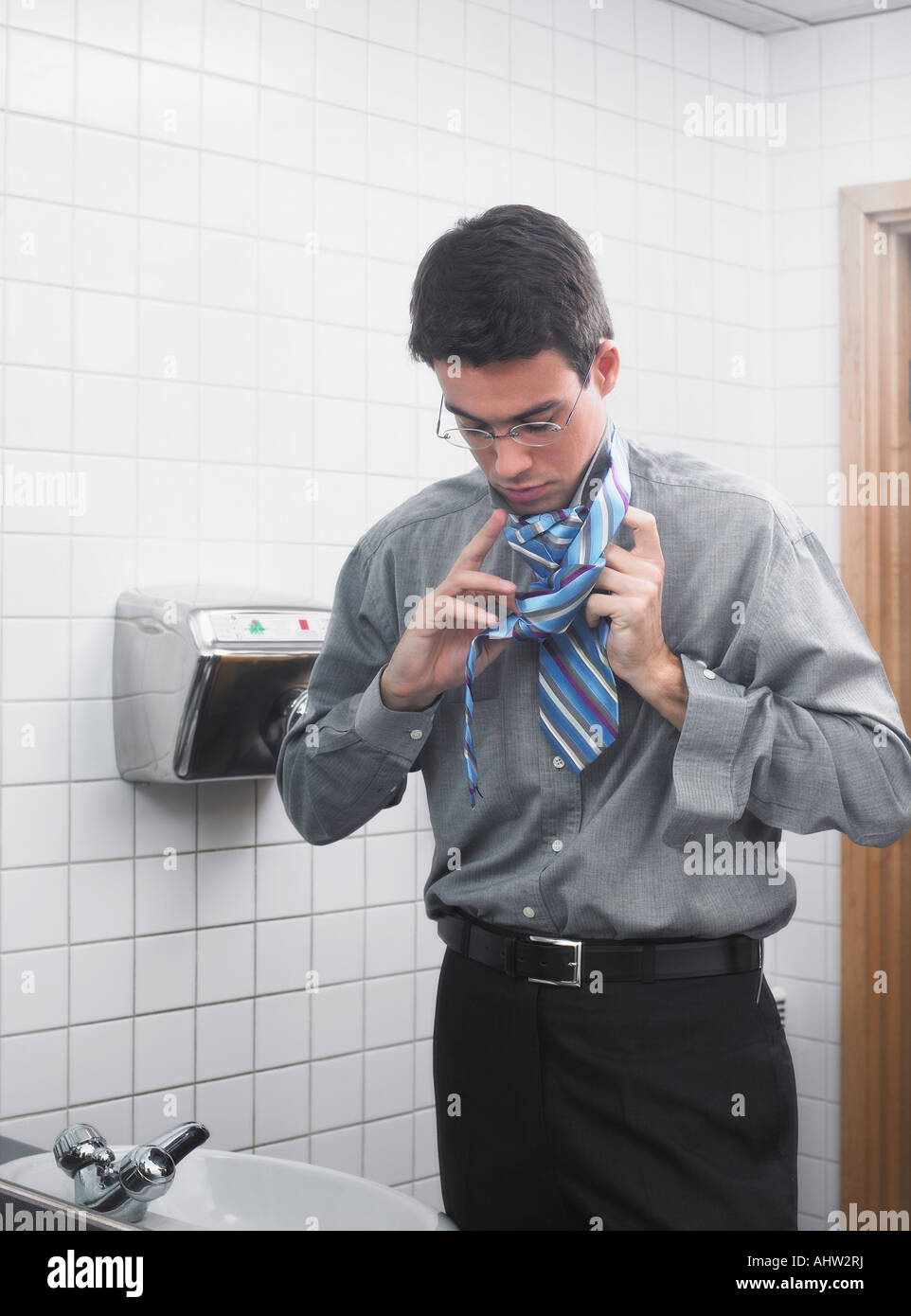 El hombre se refleja en el espejo de aseo oficina arreglando su corbata  Fotografía de stock - Alamy