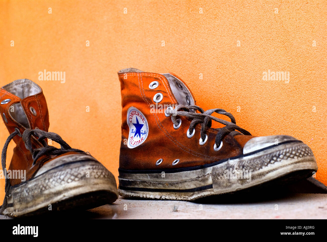 Perforación Bungalow Pelearse Viejas y sucias zapatos Converse All Star naranja sobre un fondo naranja  Fotografía de stock - Alamy