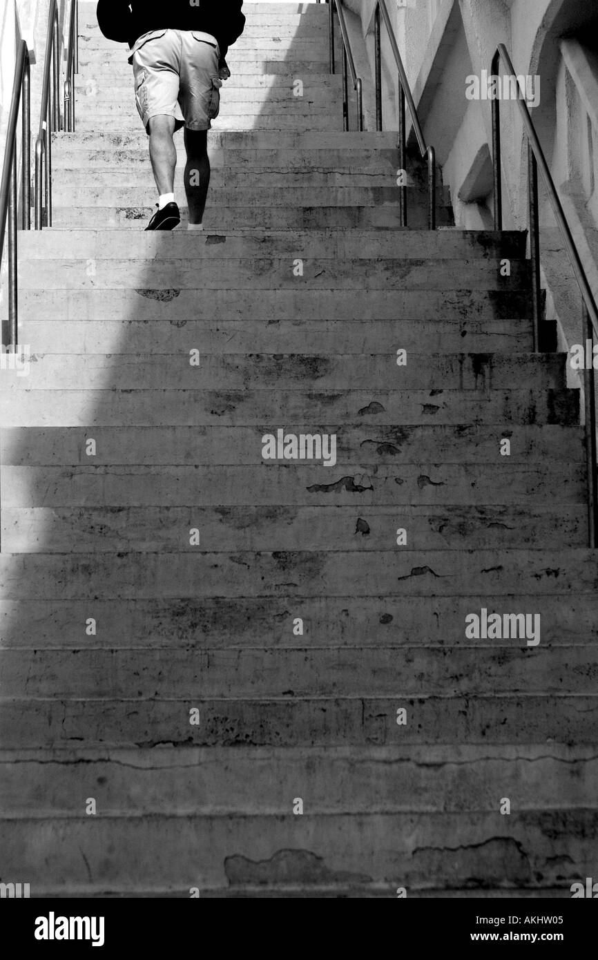 Una artística imagen en blanco y negro de un hombre subiendo un tramo de  escaleras Fotografía de stock - Alamy
