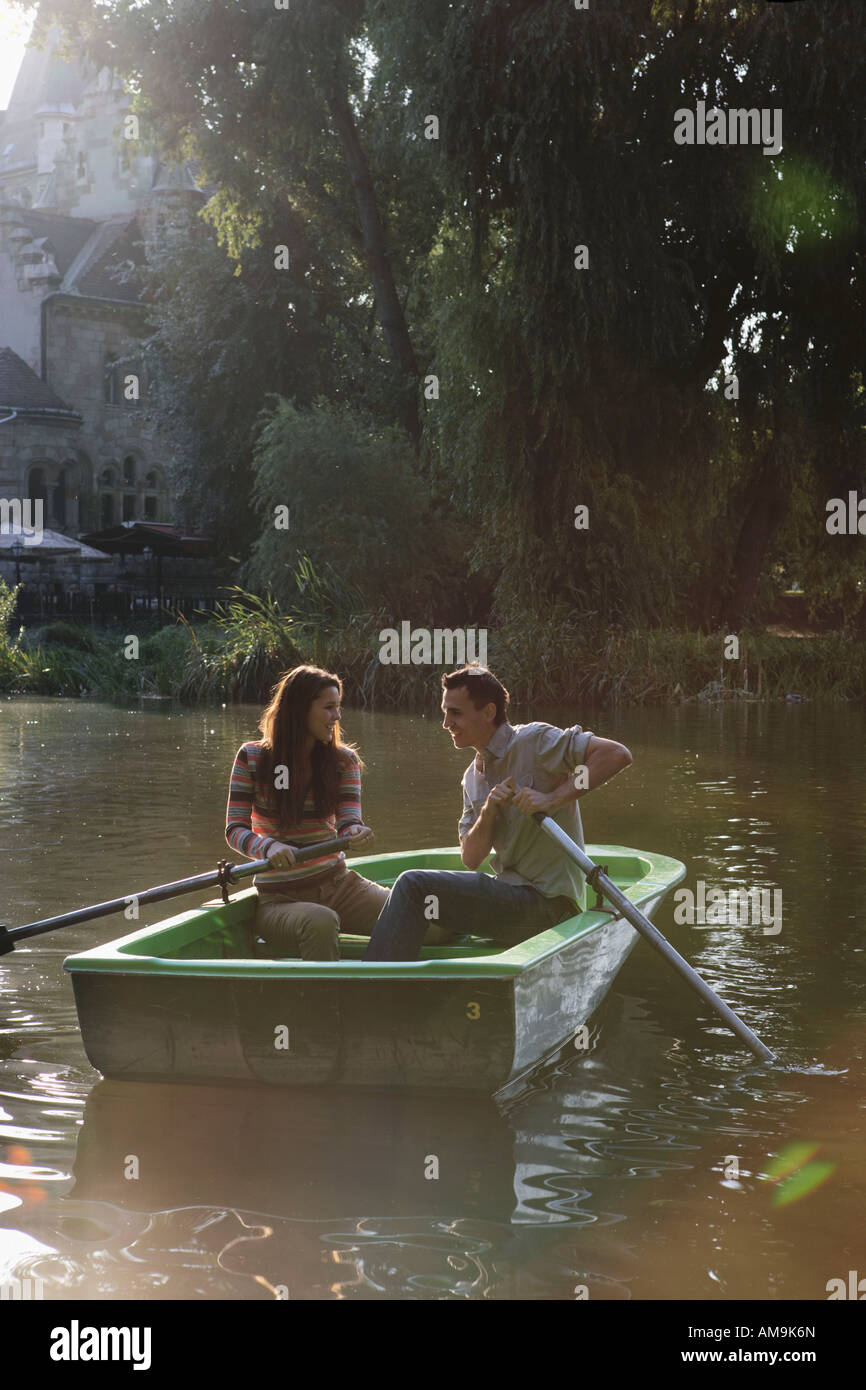 Una pareja en un bote de remo sonriendo. Foto de stock