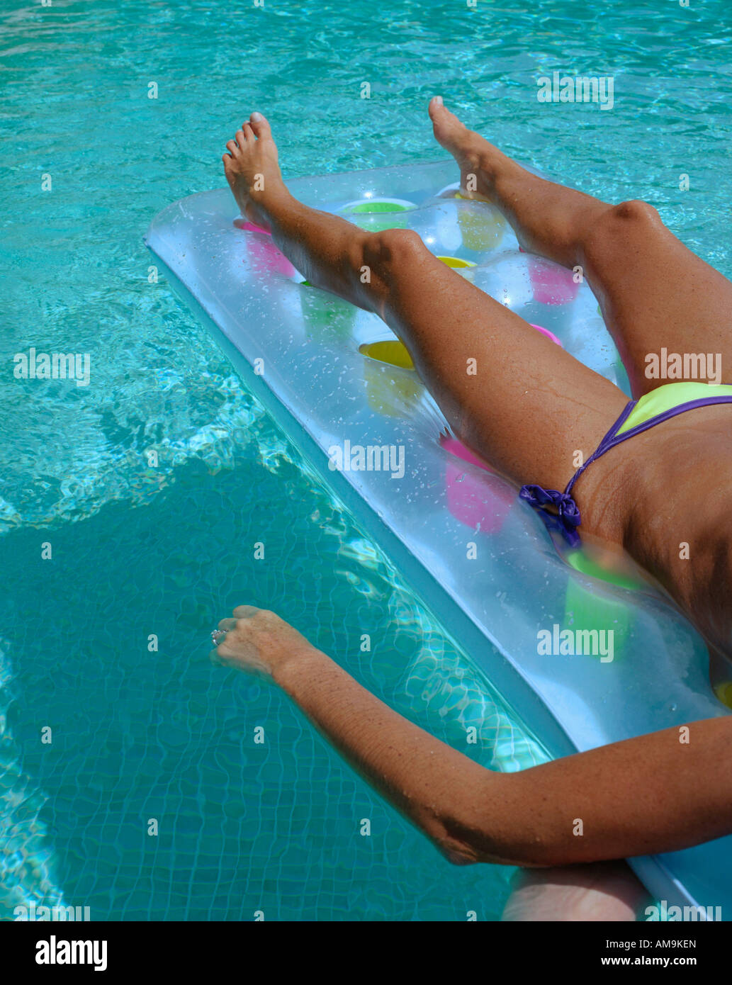 Mujer flotando en una piscina. Foto de stock