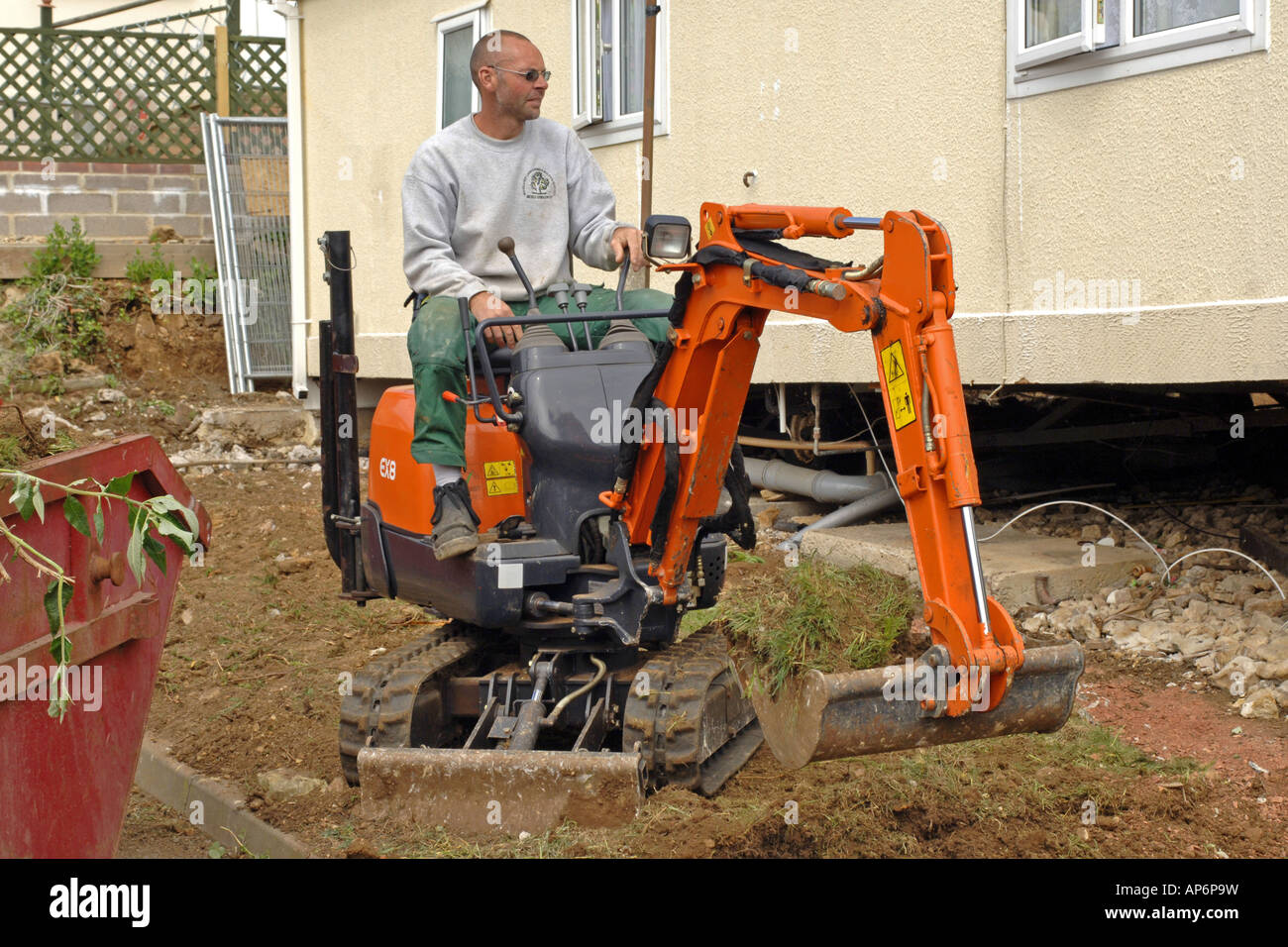 Una mini excavadora excavar el suelo desde un jardín Fotografía de stock -  Alamy