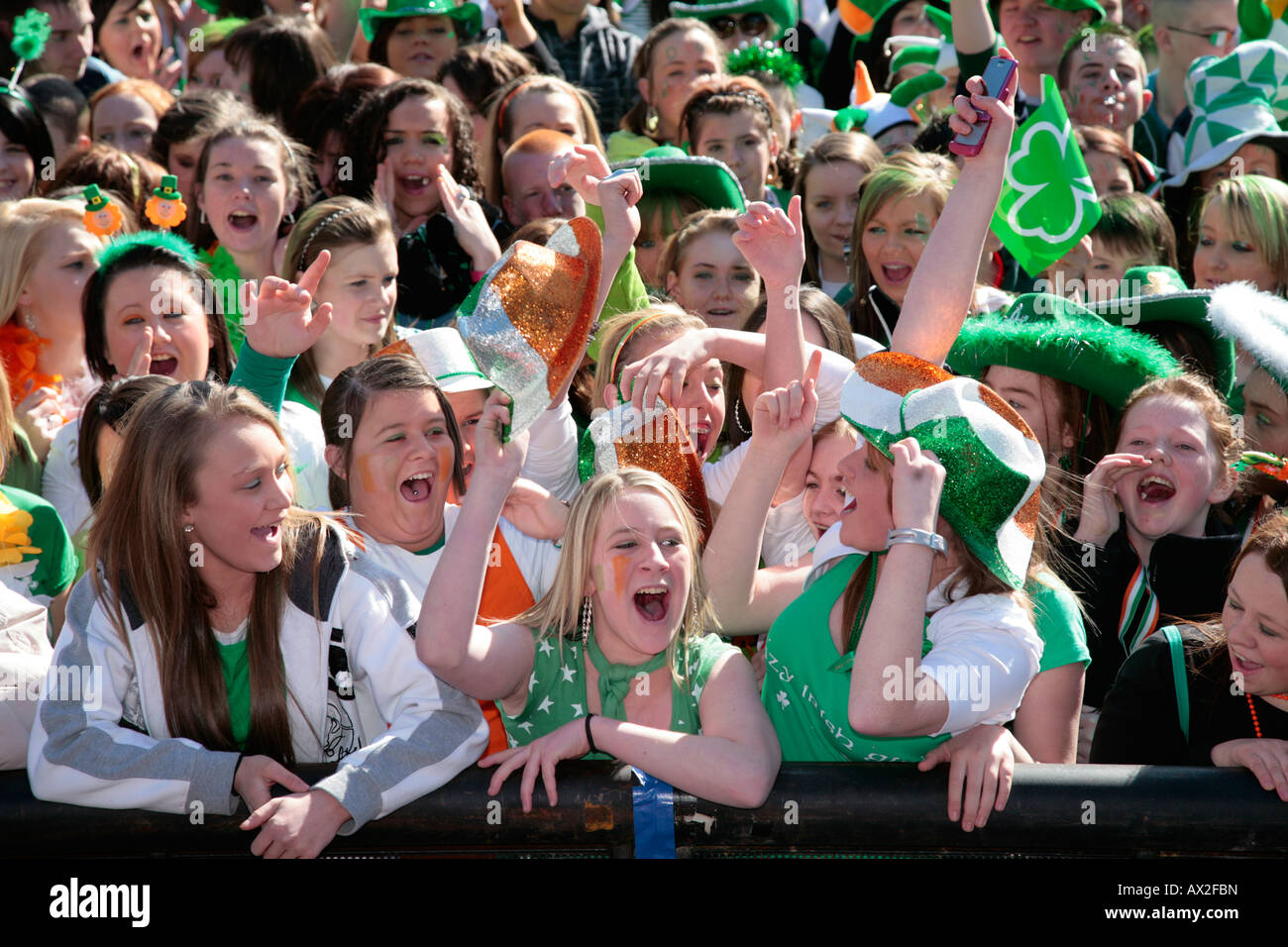 Las niñas adolescentes irlandeses en la parte delantera de la multitud en el concierto del Día de San patricio y el carnaval en Custom House square en Belfast Foto de stock