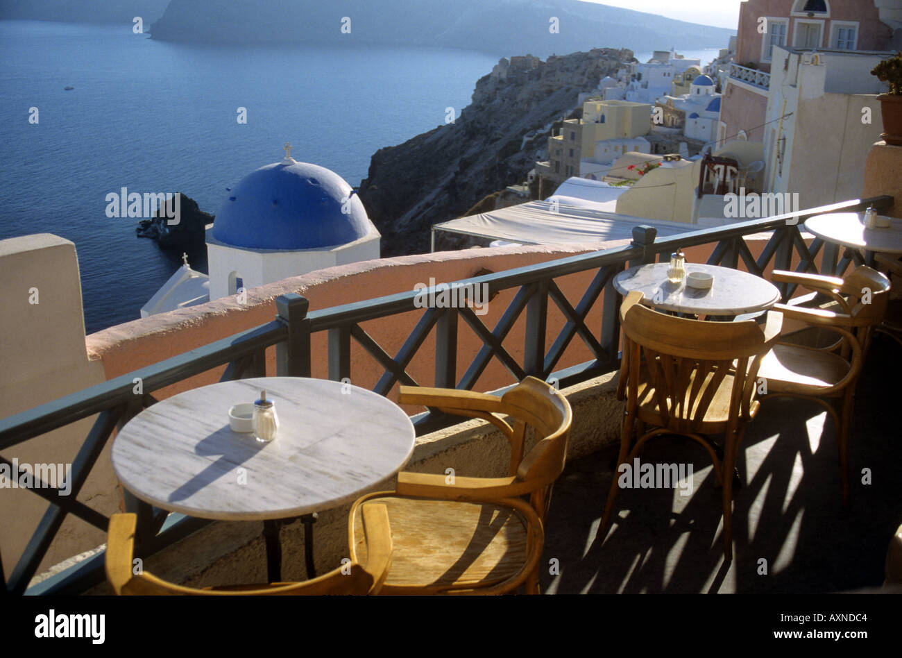 Vista desde un restaurante a través de la iglesias con cúpulas y tejados de la caldera de Santorini La Oai Cyclades Grecia Foto de stock