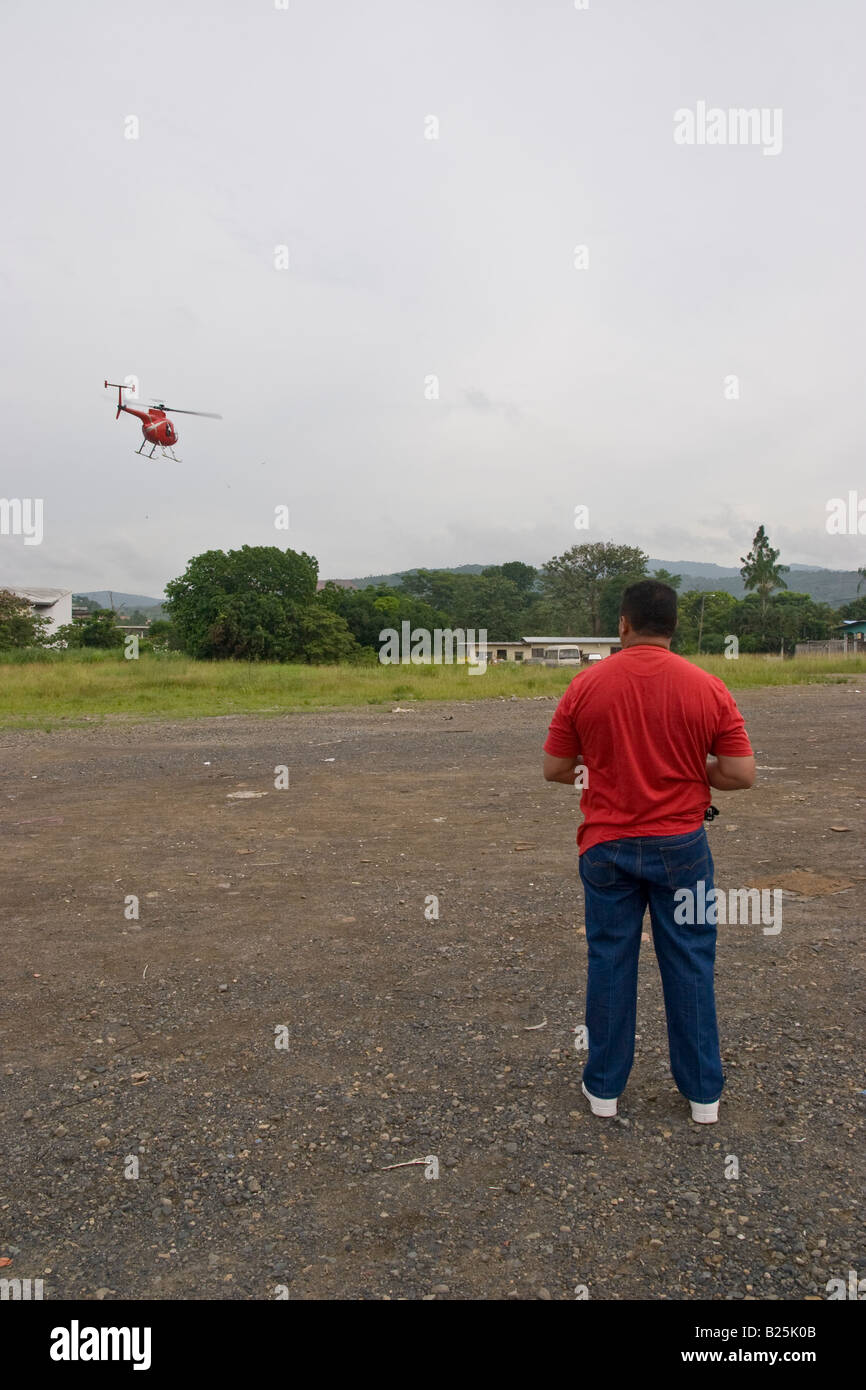 Un hombre vuela un helicóptero controlado por radio Foto de stock