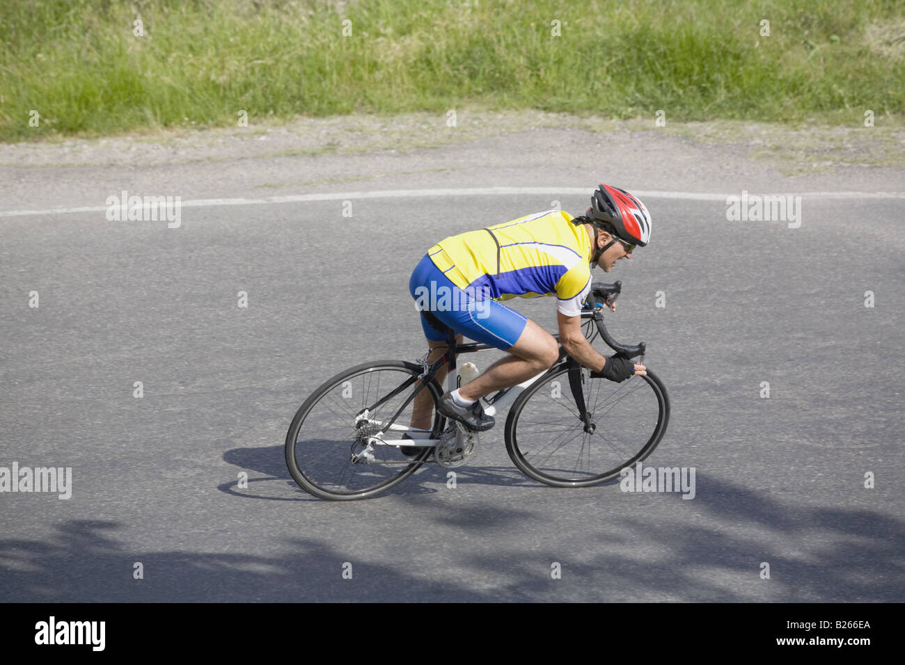 Vista lateral de un hombre ciclismo en carretera Foto de stock