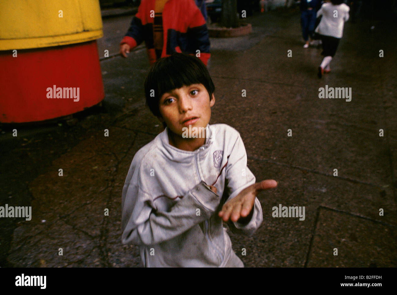 Un huérfano pidiendo limosna en la calle Foto de stock