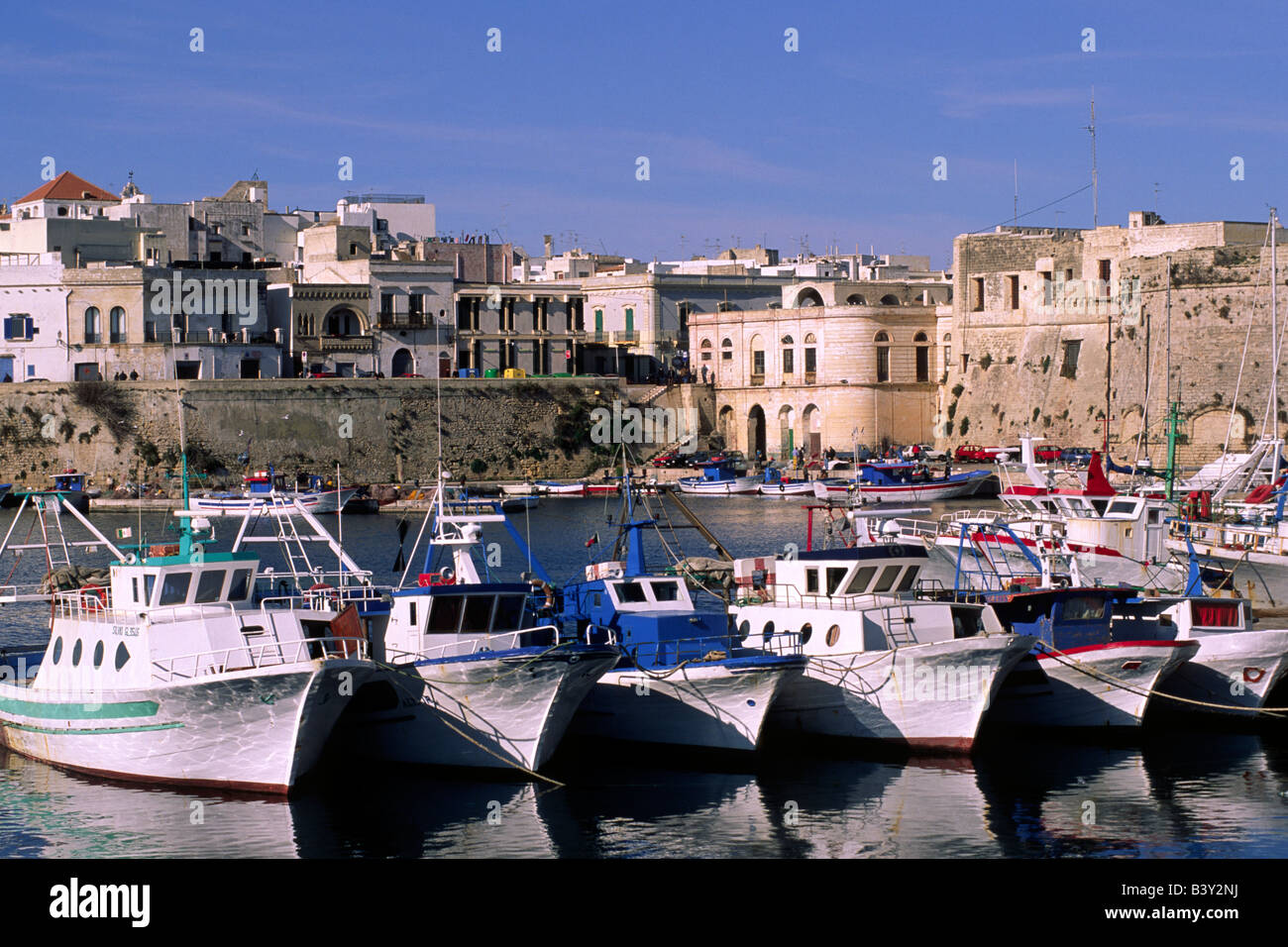 Italia, Apulia, Gallipoli, barcos de pesca, el puerto y la ciudad Foto de stock