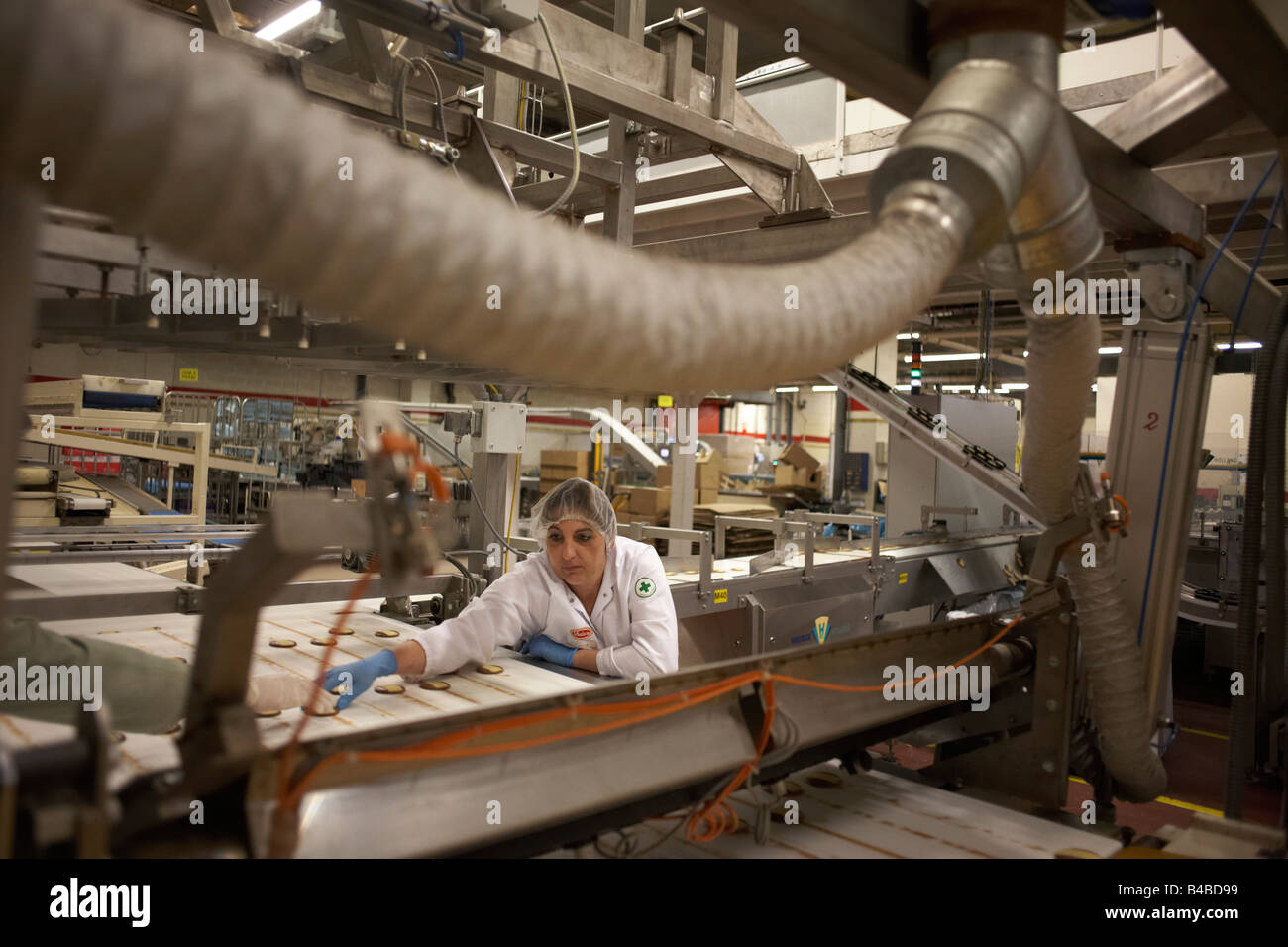 Controlador de calidad ordena a través de sub-estándar "momentos" galletas en la fábrica de producción de galletas Delacre Lambermont Foto de stock