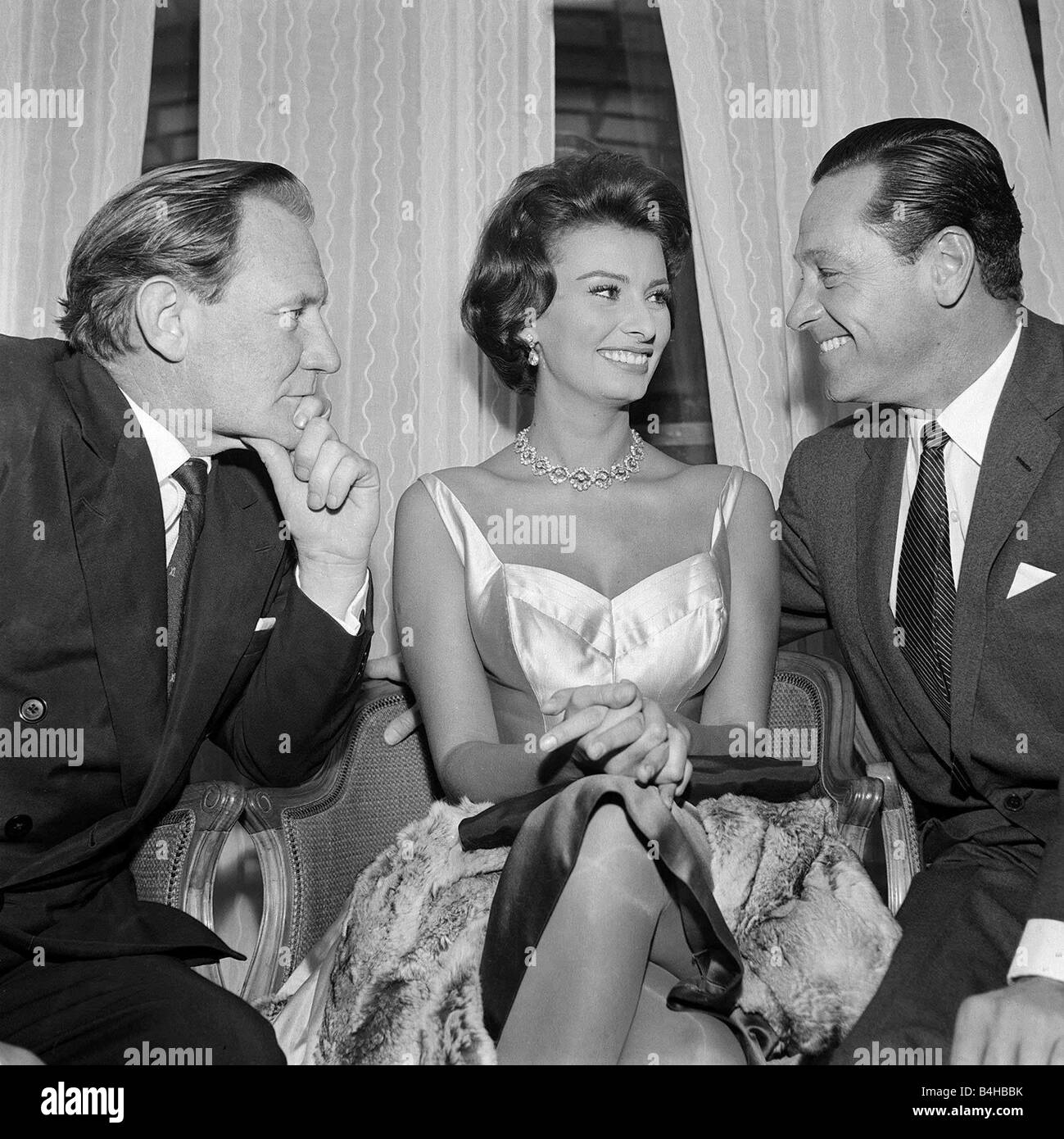 La estrella del cine Sophia Loren goza de la atención de Trevor Howard L y William Holden, diciembre de 1952 Foto de stock