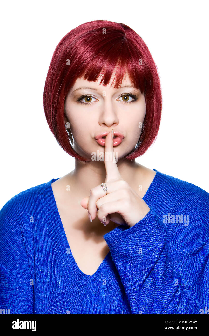 Mujer de pelo rojo la expresión facial hush Foto de stock