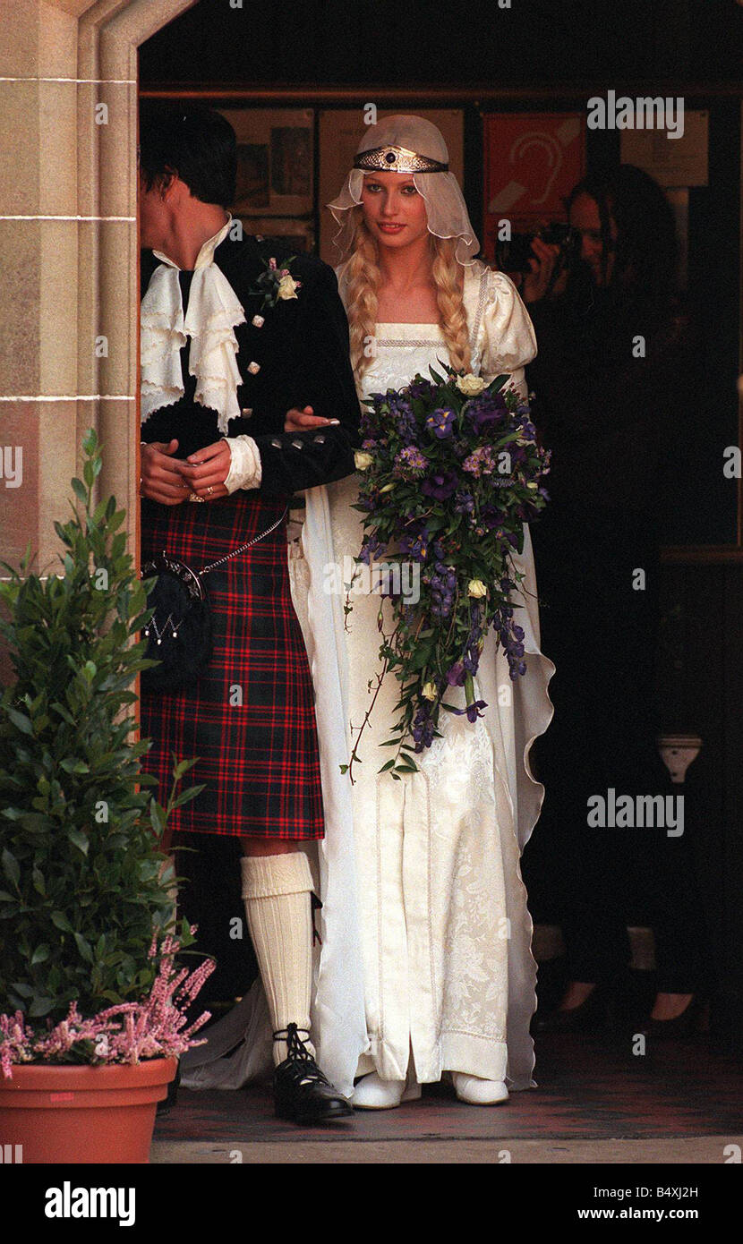 Boda de modelo Kirsty Hume y Donovan Leitch Luss de septiembre de 1997 en la iglesia parroquial de estilo medieval vestido de marfil ramo de flores azul pelo en trenzas falda Foto de stock